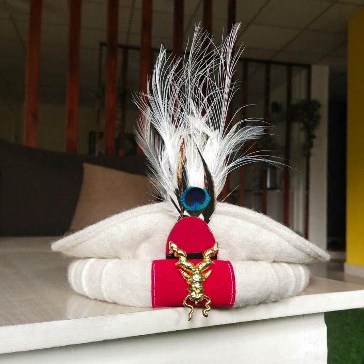 Decorative white Markhor-style traditional Pakol cap with plume and ornamental band