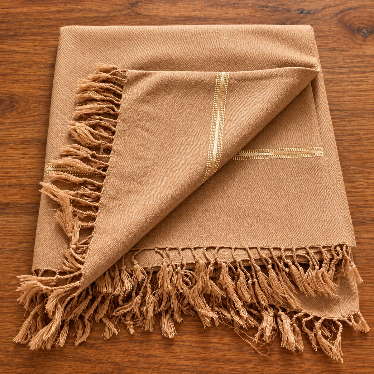 Camel-colored Pashmeena-style men's shawl photographed on a warm wooden background